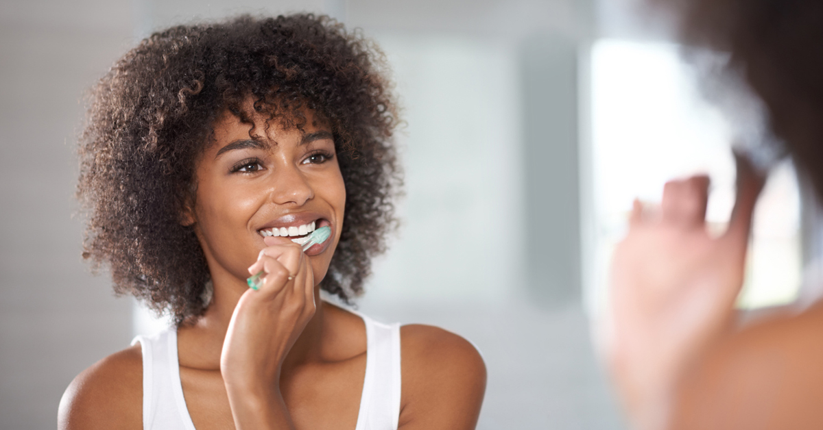 woman brushing her teeth